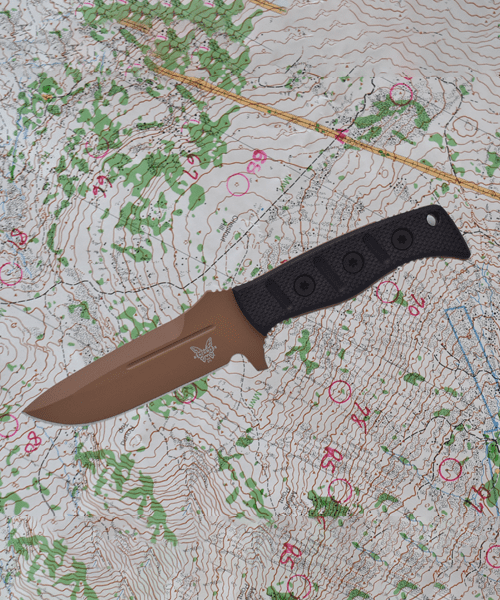 A knife that is laying on top of a map.