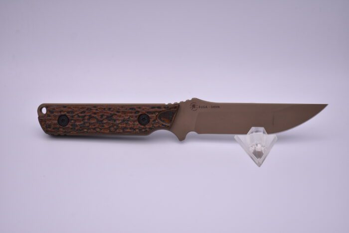 A knife with a wooden handle and brown handles.