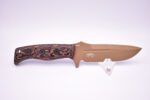 A knife with a brown handle and some flowers on it