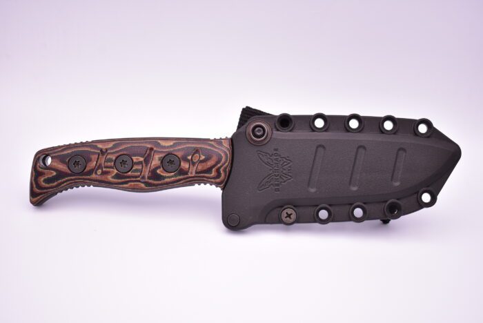 A knife with an unusual handle and a floral design.