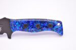 A blue knife with three black buttons on it.