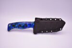 A blue knife with black handle and black sheath.