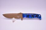 A knife with blue and black flowers on it.