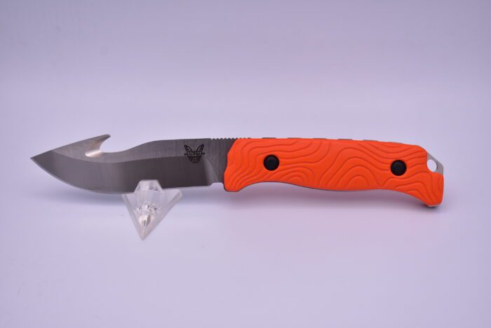 A knife with an orange handle and black blade.