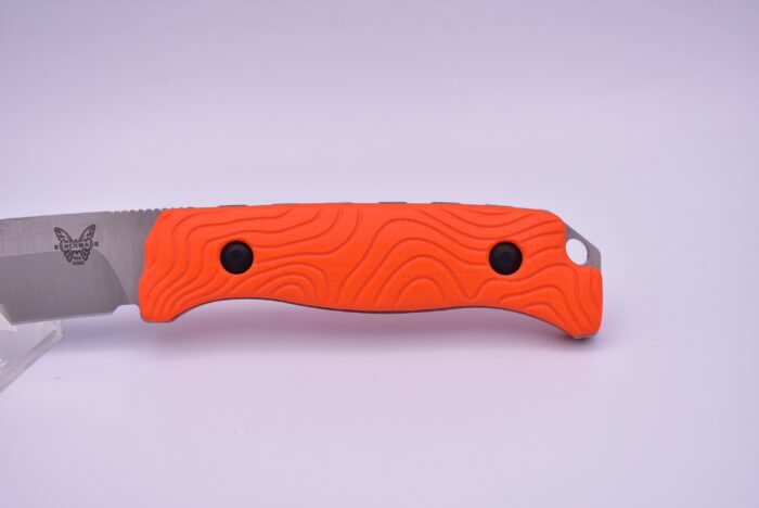 A knife with an orange handle and black dots.