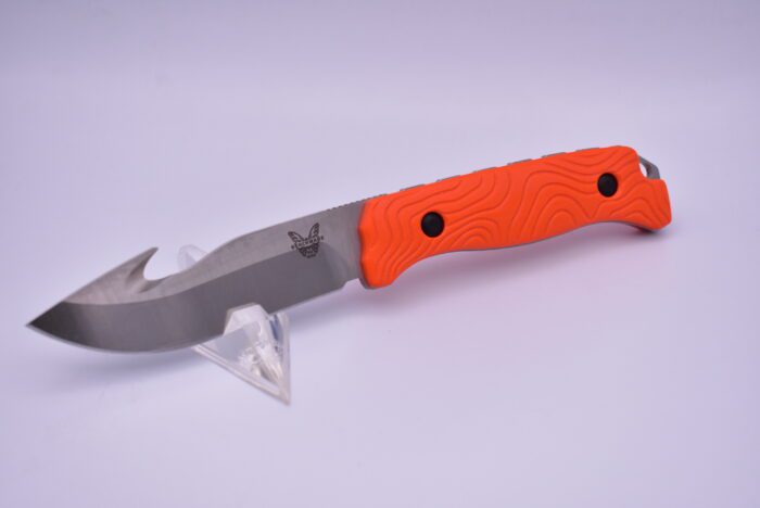 A knife with an orange handle and black handles.